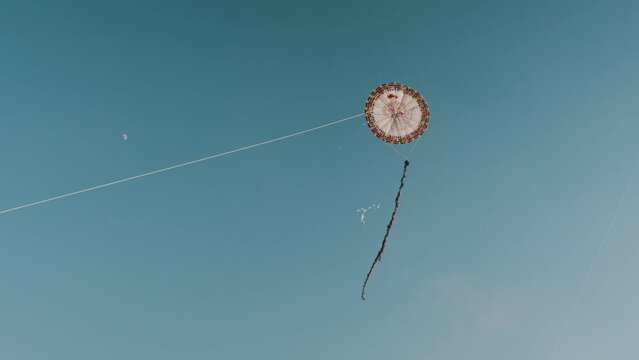 Handmade Giant Kites Flying In The Blue Sky On A Sunny Day In Sumpango, Guatemala. low angle