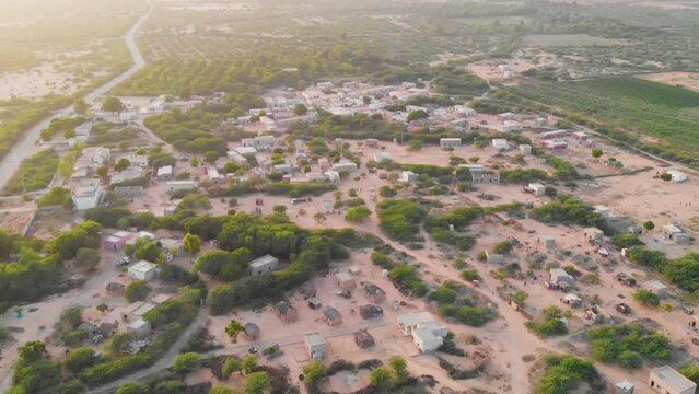 Aerial shot small village situated in the Sindh Pakistan. Overhead Tilt Up View Over Village Rooftop In Sindh.
