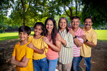 Happy indian or asian family at park