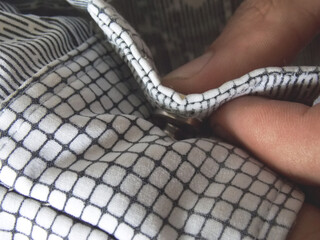 Buttoning the shirt sleeve. Close-up