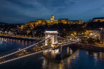 Luftaufnahme der Budaer Burg und der Szechenyi-Kettenbrücke über die Donau in der Abenddämmerung in Budapest, Ungarn.