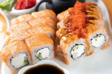 sushi and rolls on an orange background