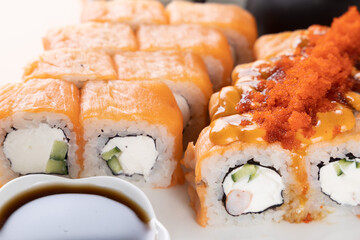 sushi and rolls on an orange background