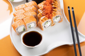 sushi and rolls on an orange background