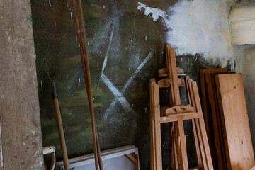Some old painting utensils placed near the concrete wall