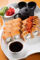 sushi and rolls on an orange background