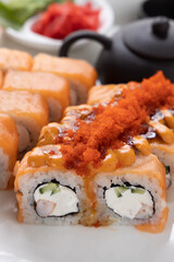sushi and rolls on an orange background