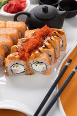 sushi and rolls on an orange background