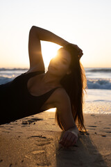 Fototapeta na wymiar Girl on the beach sunset