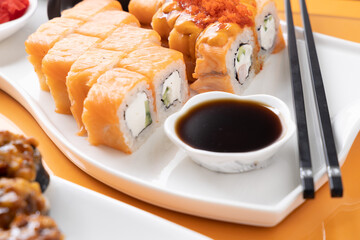 sushi and rolls on an orange background