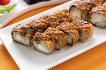 sushi and rolls on an orange background