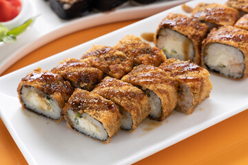 sushi and rolls on an orange background