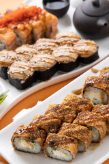 sushi and rolls on an orange background