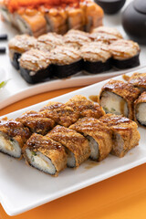 sushi and rolls on an orange background
