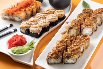 sushi and rolls on an orange background