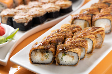 sushi and rolls on an orange background