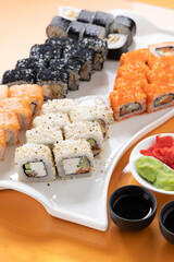 sushi and rolls on an orange background