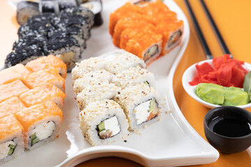 sushi and rolls on an orange background