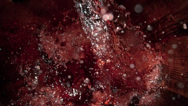 Super Slow Motion Shot of Pouring Red Wine into Old Oak Wooden Barrel at 1000fps.