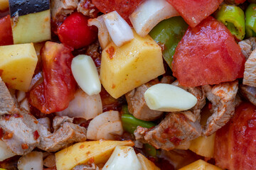 Top view of Turkish dish Guvech - baked meat with eggplant and traditionally served in earthenware pot (Turkish name; etli patlican guvec)