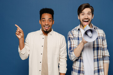 Young two friend happy fun men wear white casual shirts together hold scream in megaphone announces...
