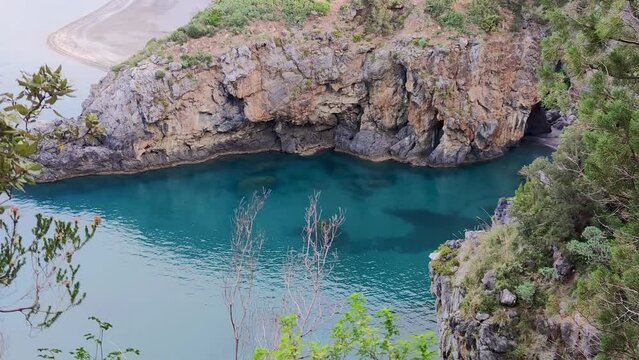 Breathtaking Aerial View of the Tarren Sea with Turquoise Clear Waters of Arco Magno Beach. San Nicola Arcella, Province of Cosenza, Calabria, Italy. Slow Motion Video.