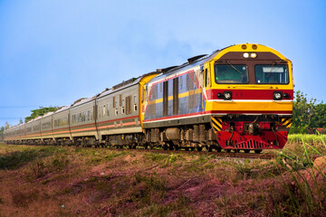 Naklejka premium Passenger train by diesel locomotive on the railway.