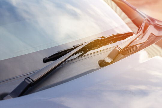 Brushes on the car glass . The work of windshield wipers - brushes and an evening sunbeam.