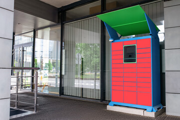 Fototapeta premium Parcel locker with many postal boxes near building outdoors