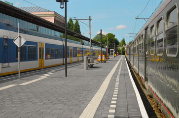 Fototapeta na wymiar Modern trains at railway station on sunny day