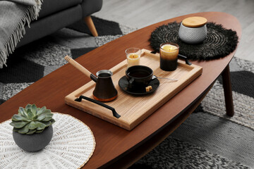Obraz na płótnie Canvas Tray with freshly made coffee and decorative elements on wooden table in room