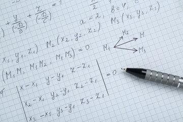 Sheet of paper with different mathematical formulas and pen, top view