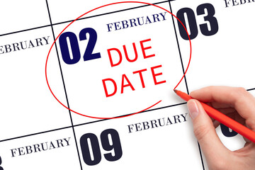 Hand writing text DUE DATE on calendar date February 2 and circling it. Payment due date