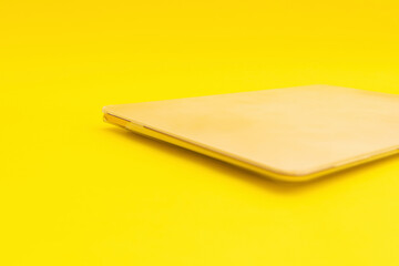Laptop lies on a golden background