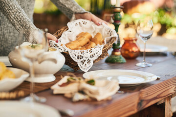 Food, bread and party with hands of woman at dinner table for hospitality, holiday or celebration....