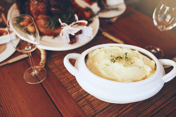 Food, mashed potatoes and dining table for thanksgiving or Christmas holiday celebration with home cooking for lunch or dinner nutrition. Puree potato, roasted chicken and wine glass background