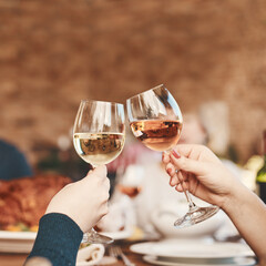 Hands, wine glass and toast with wine at party, holiday celebration and couple drinking. Dinner party, celebrate together with food, drink and celebrating Christmas, Thanksgiving or anniversary.