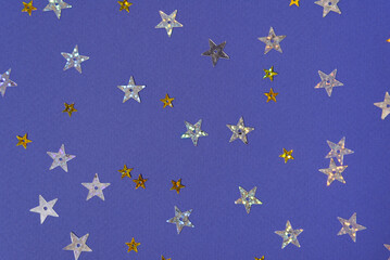Silver and gold stars on a purple background. Festive background for your ideas