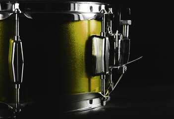 Musical instrument. Drum in low key. Snare drum in backlight. Yellow drum