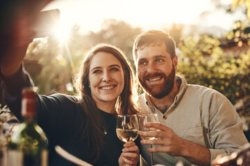 Phone selfie, wine toast and couple on romantic love date for marriage anniversary, outdoor freedom or peace. Picture flare, fine dining and wine tasting man and woman bonding at vineyard restaurant