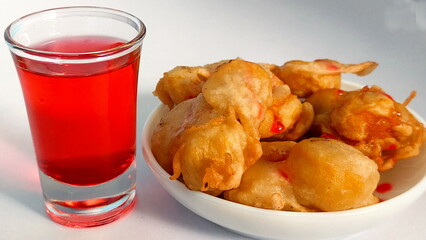 Indonesian style fried banana and refreshing sweet red strawberry drinking water