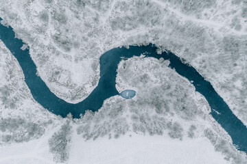 Aerial top view of winding blue river, snow winter landscape