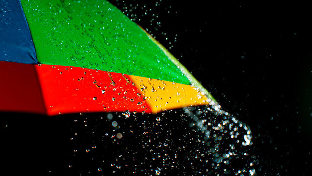 Rain drops on colored umbrella, freeze motion