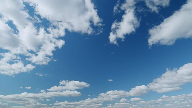 Puffy fluffy white clouds. Forming cloud moving with blue sunny, summer skies. Timelapse.