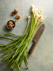 Food background, bunch of green garlic and walnut