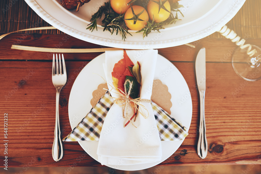 Wall mural Plate, Christmas and celebration with a table setting on a wooden surface in the festive season from above. Party, still life and cutlery with a napkin on a serving dish in an empty home with flare