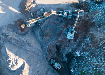 Concrete Recycling and asphalt from demolition. Excavator at landfill the load concrete waste in a...