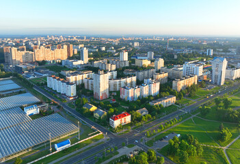 Fototapeta na wymiar Residential buildings, top view. View of the city with multi-storey houses and buildings. Residential house in green area in city, town, aerial view. Car parking in the courtyard of the townhouse. 