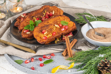 Traditional Christmas Rabanadas with lemon zest, pomegranate, pine nuts and cinnamon. Spanish...