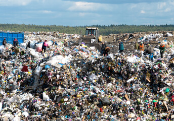 Solid waste disposal and landfill gas collection. Landfill with solid household waste. Dozer on Garbage dump with waste plastic and polyethylene. Environmental pollution.